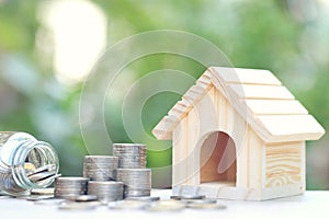 Finance, Stack of coins money and Model house on natural green background, Business investment and real estate