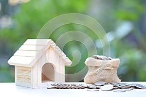 Finance, Stack of coins money and Model house on natural green background, Business investment and real estate