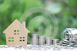 Finance, Stack of coins money and Model house on natural green background, Business investment and real estate