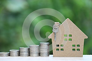 Finance, Stack of coins money and Model house on natural green background, Business investment and real estate