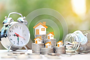 Finance, Stack of coins money and Model house on natural green background, Business investment and real estate