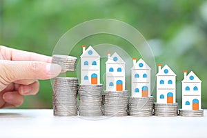 Finance, Stack of coins money and Model house on natural green background, Business investment and real estate