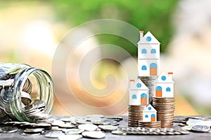 Finance, Stack of coins money and Model house on natural green background, Business investment and real estate