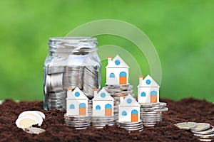 Finance, Stack of coins money and Model house on natural green background, Business investment and real estate