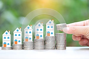 Finance, Stack of coins money and Model house on natural green background, Business investment and real estate