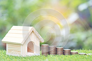 Finance, Stack of coins money and Model house on natural green backgroundd, Saving for prepare in future