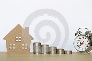 Finance, Stack of coins money and Model house on wtite background, Business investment and real estate