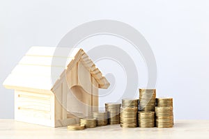 Finance, Stack of coins money and Model house on wtite background, Saving money for prepare in future and real estate concept