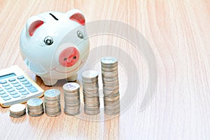 Finance stack coins and piggy bank on wood table