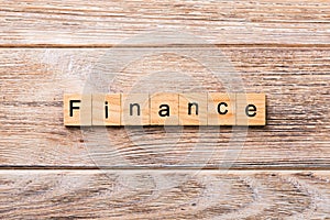 FINANCE word written on wood block. FINANCE text on wooden table for your desing, concept