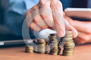 Finances and budgeting, businessman stacking coins