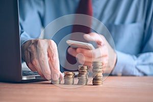 Finances and budgeting, businessman stacking coins