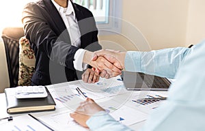 Financial accountants and marketers shaking hand to congratulate the double-digit real estate performance