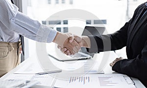 Financial accountants and marketers shaking hand to congratulate the double-digit real estate performance