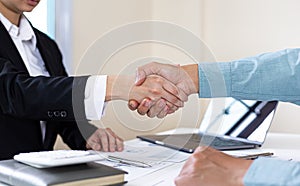 Financial accountants and marketers shaking hand to congratulate the double-digit real estate performance photo