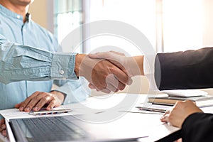 Financial accountants and marketers shaking hand to congratulate the double-digit real estate performance photo