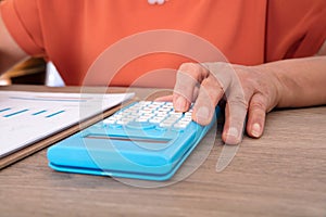 Financial accountants are using calculators to analyze and check financial materials