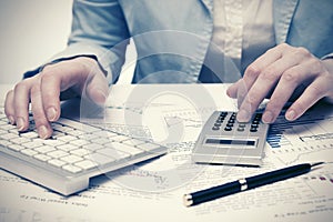 Financial accounting Business woman using calculator and computer keyboard