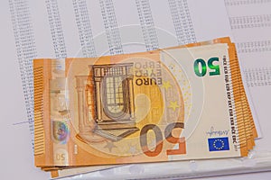 Financial Accounting document with euro notes close up.