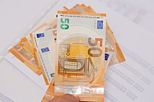 Financial Accounting document with euro notes close up.