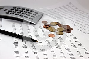 Financial accounting, Image a plurality of numbers on paper and calculator, coins. photo