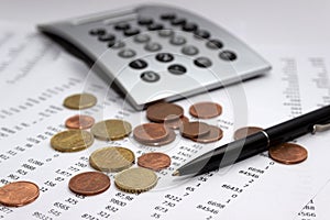 Financial accounting, Image a plurality of numbers on paper and calculator, coins. photo