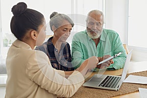 Financial adviser discussing information with a couple photo
