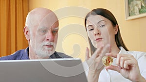 Financial adviser showing senior male client cryptocurrency bitcoin. Pension savings and ebusiness