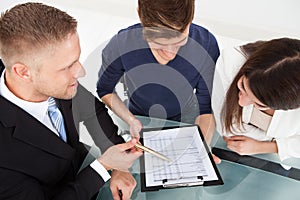 Financial advisor explaining investment plan to couple