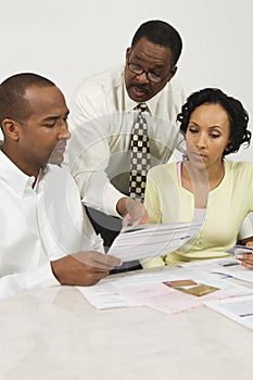 Financial Advisor Explaining Plans To Couple