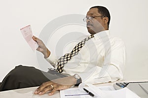 Financial Advisor Reading Document In Office