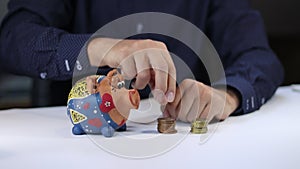 Financial advisor shows how much money you save on their services. A man puts the saved money into a piggy bank. Financial institu