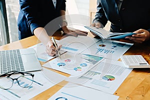 Financial advisory services. Group of business advisor showing plan of investment to clients in the consultancy office photo