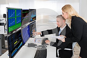 Financial Agents Monitoring Computer Screens In Office