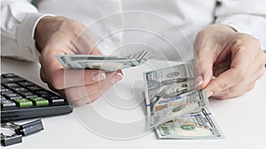 financial business concept. close-up woman hands counting money us dollar.