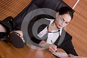 Financial business woman legs on desk