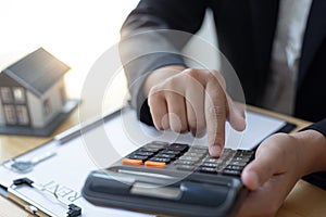 Financial businessmen are calculating and analyzing property investment costs