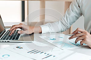 Financial businessmen use laptop to analyze marketing strategies and real estate data to reduce company taxes for their customers