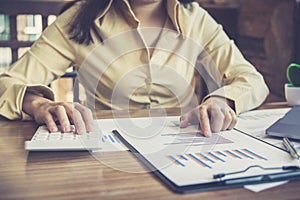 Financial businesswoman calculating corporate income tax data And analyzing charts of financial stocks that are in good condition