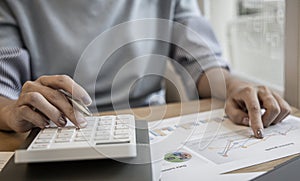 Financial businesswoman calculating corporate income tax data And analyzing charts of financial stocks that are in good condition