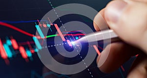 Financial chart with pen, stock analysis data for business background on digital screen. Graphs of the growth of the financial