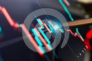 Financial chart with pen, stock analysis data for business background on digital screen. Graphs of the growth of the financial