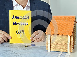 Financial concept about Assumable Mortgage with sign on blank book