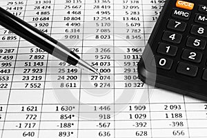 Financial concept. Calculator, pen and glasses on financial documents. Financial accounting. Balance sheets. Closeup of financial