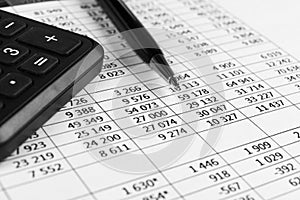 Financial concept. Calculator, pen and glasses on financial documents. Financial accounting. Balance sheets. Closeup of financial