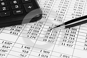 Financial concept. Calculator, pen and glasses on financial documents. Financial accounting. Balance sheets. Closeup of financial