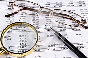 Financial concept. Calculator, pen and glasses on financial documents. Financial accounting. Balance sheets. Closeup of financial