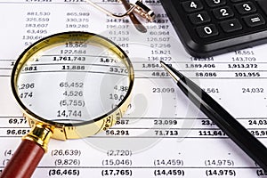 Financial concept. Calculator, pen and glasses on financial documents. Financial accounting. Balance sheets. Closeup of financial