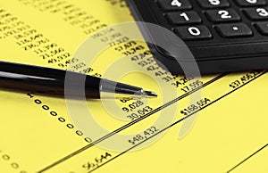 Financial concept. Calculator, pen and glasses on financial documents. Financial accounting. Balance sheets. Closeup of financial