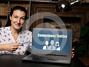 Financial concept about Competency Testing with sign on laptop